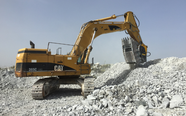 La benna frantoio BF135.8 installata sull'escavatore Caterpillar 365 frantuma il talco da riutilizzare per la produzione di calcestruzzo